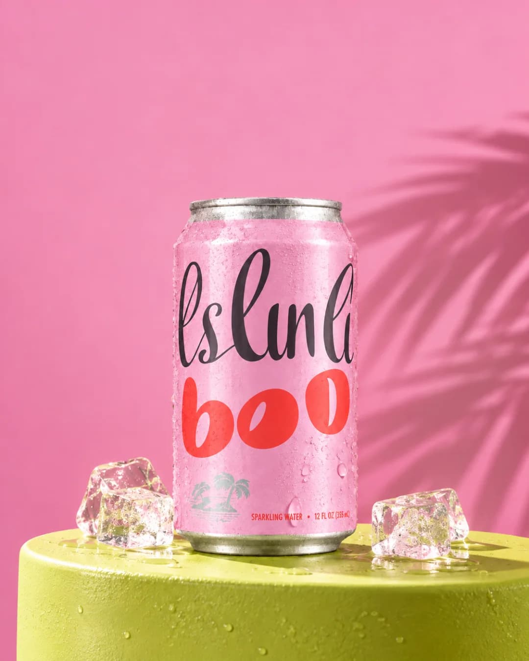 The pink can on a green plinth against a pink backdrop